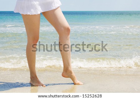 nice legs on the beach, beautiful blue sea background