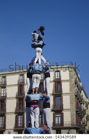 BARCELONA - FEBRUARY 13: Local festivities in Barcelona. The group of castellers called Castellers del Poble Sec; are building a human castle. February 13, 2011 Barcelona, Spain