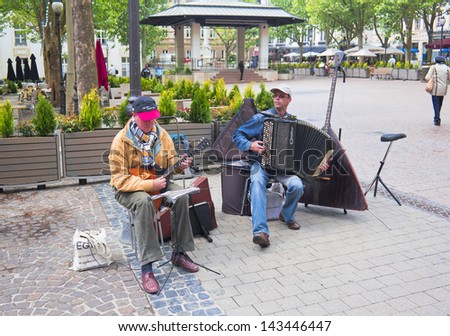 LUXEMBOURG - MAY 15: Two musicians playing the balalaika and accordion in a square of Luxembourg Balalaika is a russian musical instrument, similar like a guitar. May, 15 2011 Luxembourg