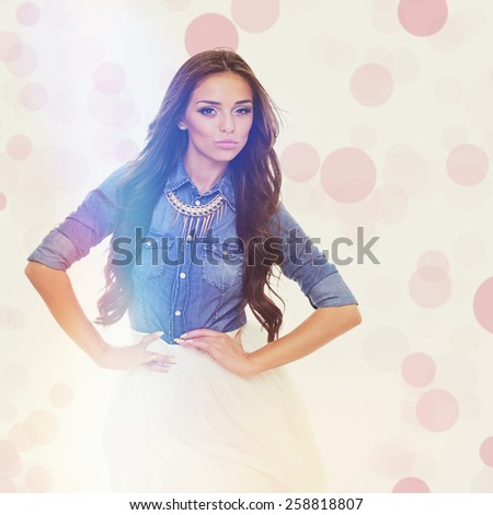 Trendy pretty woman in summer outfit. Gorgeous brunette girl in denim shirt and white skirt laughing and posing. Retouched, square format, matte instagram filter look, pink bokeh effect.