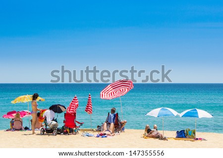 CALONGE, SPAIN - 25 JUNE: Tourists enjoy at the beach in the summer in the Calonge beach, small village in Costa Brava. Calonge July 12, 2013.