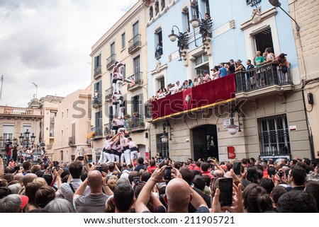 BARCELONA, SPAIN - AUGUST 17:  Group of people makes human tower in Festes de Gracia, Barcelona. Catalan human towers are on UNESCO\'s Cultural Heritage List. August 17, 2014 Barcelona.