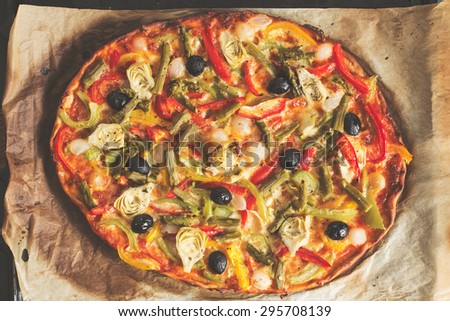 Top view of a homemade vegetables pizza. Vintage edition.