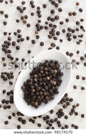 View of a pepper bowl from the top on a white textile background with space for designers.