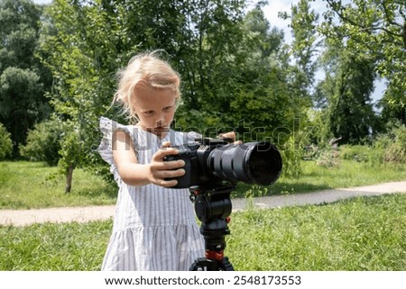 Similar – Foto Bild Junge blonde Hobby-Fotografin lächelt verschmitzt in die Kamera