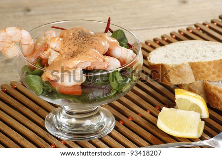 prawn cocktail crusty bread and lemon wedges with salad and seafood dressing
