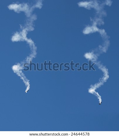Synchronous Aerobatic aircraft in a spin with smoke trails