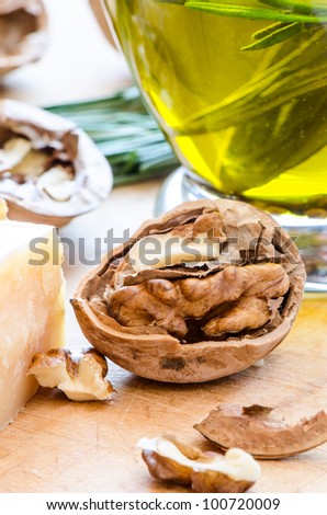 Nut parmesan and olive oil on wooden cutting board