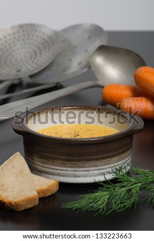Fresh Vegan Carrot and Potato Soup on table in kitchen