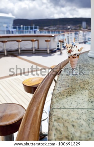 Cup of ice cream in an outdoor cafe on open deck of cruise ship