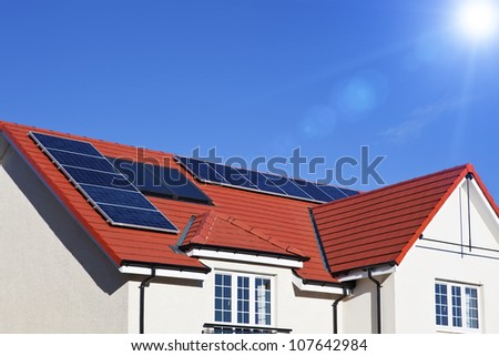 Alternative energy photovoltaic solar panels on tiled house roof