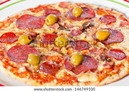 Bacon and pepperoni pizza with green olives. More food photographs in my portfolio.