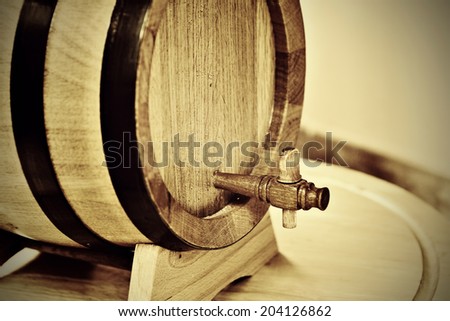 Small traditional oak household wine cask with wooden tap