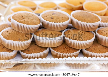 Brown cupcakes on silver tray in a hotel restaurant served for breakfast. Healthy eating choice