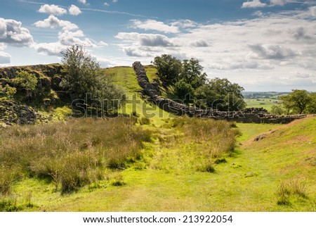 Hadrians Wall in valley / Hadrians Wall is a World Heritage Site at the start of the beautiful Northumberland National Park