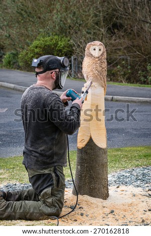 Owl Sculptor working / The making of an owl sculpture by a chainsaw sculptor here in the latter stages