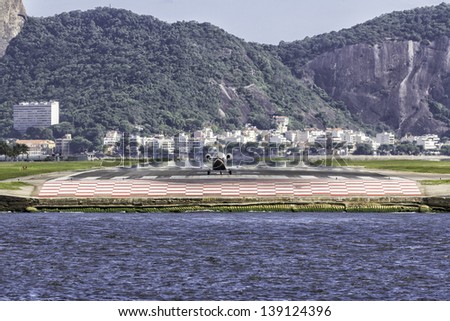 Jet ready to take off against Sugar Loaf mountain in Rio de Janeiro