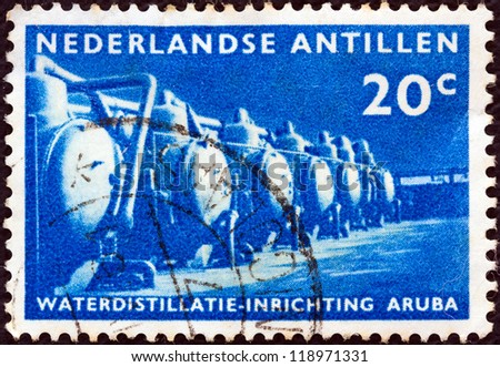 NETHERLANDS ANTILLES - CIRCA 1959: A stamp printed in the Netherlands issued for the inauguration of Aruba water distillation plant shows water distillation plant, circa 1959.