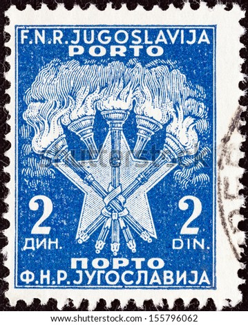 YUGOSLAVIA - CIRCA 1952: A stamp printed in Yugoslavia shows 5 Torches and Star, the Coat of Arms of Yugoslavia, circa 1952.