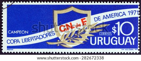 URUGUAY - CIRCA 1971: A stamp printed in Uruguay issued for Uruguay\'s victory in the Liberators of America Cup shows shield and laurel, circa 1971.