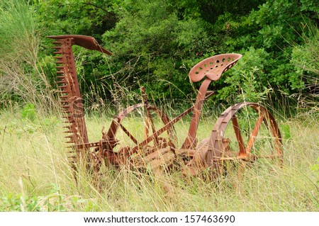 Old rusty thresher standing in the landscape exposed to the elements of nature