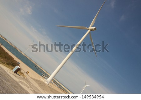 Big white windmills farm near Brouwers-dam in Netherlands.
