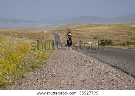 Travel by bicycles in Armenia - man on the bicycles on the route