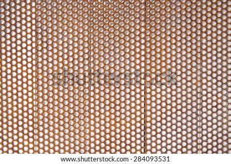 Background composed with perforated metal sheet and in an advanced oxidation state