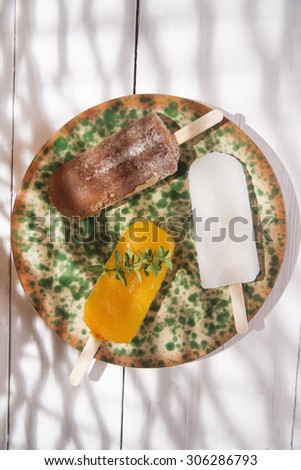 Presentation of three icicles summer fruit on colorful plate