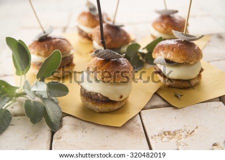 Small hamburger meat and cheese with sage leaves