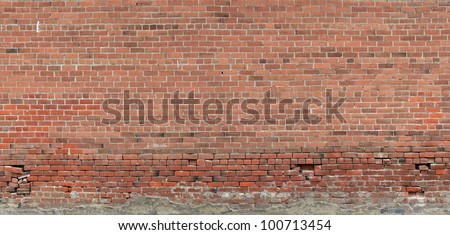 Panorama of an aged brick wall with lots of weathering and missing mortar areas along the lower portion of the wall./ Very Old, Weathered and Worn Brick Wall / Great background, texture or example.