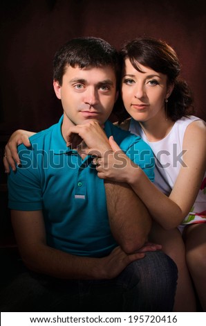 Happy couple in love posing in studio. Loving couple embracing. Beautiful woman and man in casual summer clothes. Relationship/ Boyfriend and girlfriend on dating.