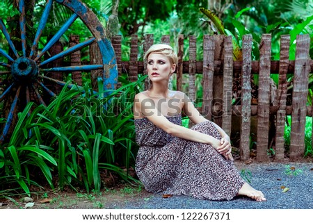 portrait of sensual woman sitting in the forest