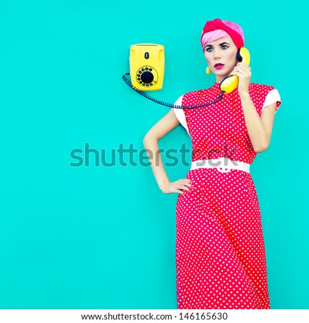 Retro fashion girl talking on a vintage telephone