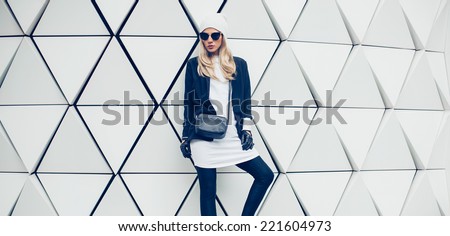 Similar – Image, Stock Photo Woman in black winter jacket and cap looking at black roadster on parking lot