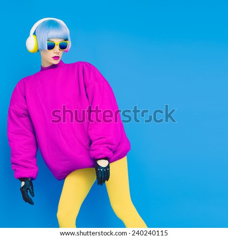 Glamorous fashion Lady in bright clothes listening to music. All shades of music