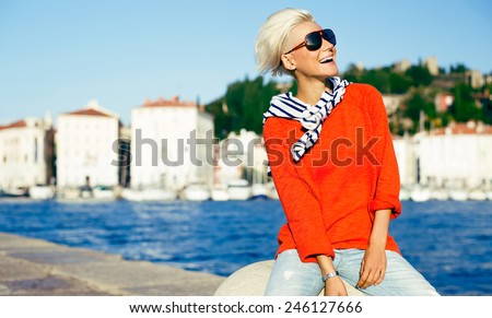 Happy Stylish Blonde woman on vacation. Travel. Marine style fashion