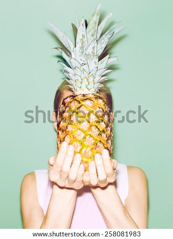 Girl holding Pineapple. Fashionable stylish summer