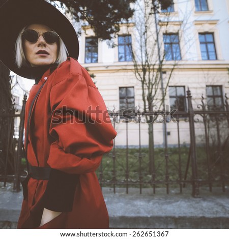 Sensual blond woman in vintage clothing on the city street