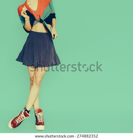 Playful Girl in skirt polka dot on blue background. Vintage style