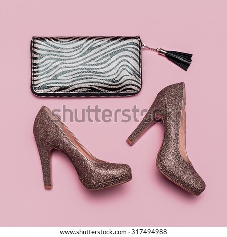 Fashion Shoes and Clutch on pink background. Gold accent