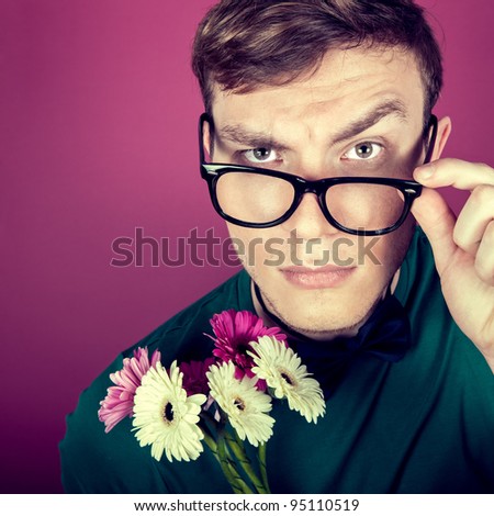 Young beautiful man with flowers