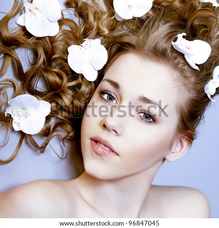 beauty close-up portrait young woman face with flowers
