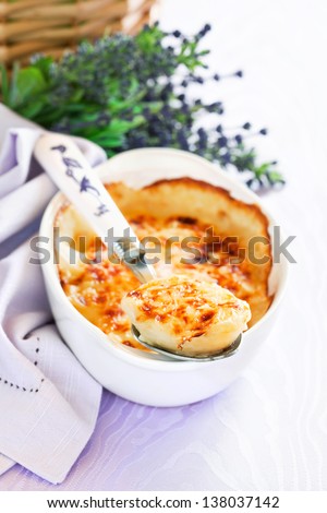 Boiled eggs baked with sauce and cheese (Gratin provencal eggs), selective focus
