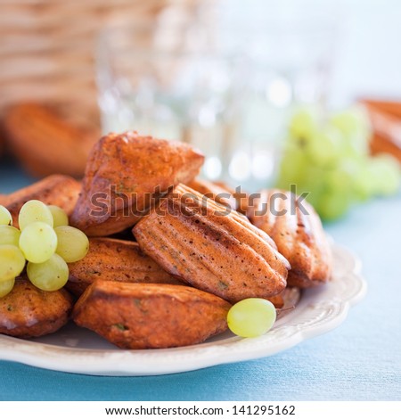 Cheese oat bran madeleines cookies with paprika and grapes. Selective focus