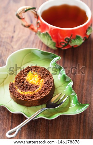 Chocolate swiss roll with pumpkin and orange. Selective focus