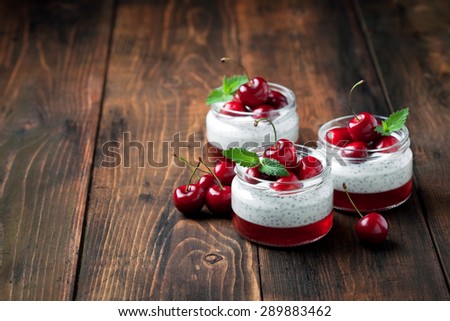 Chia seeds yogurt pudding, jelly and fresh sweet cherries in jar, selective focus