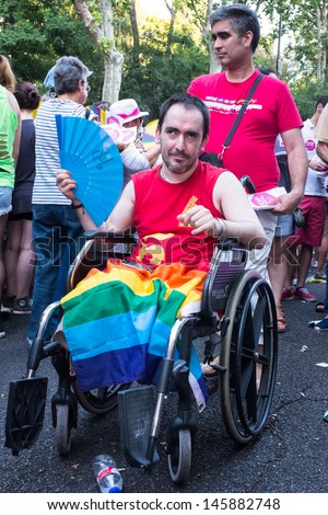 MADRID, SPAIN - JULY, 6: Unidentified handicapped man wears a rainbow flag at the Gay Pride parade on July 6, 2013 in Madrid (Spain). Near 1,200,000 people participated at this Gay Pride Parade.