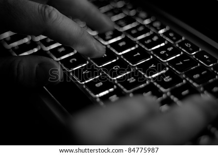 black computer keyboard with hands