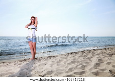 The young happy woman on a beach sea and sky vacation